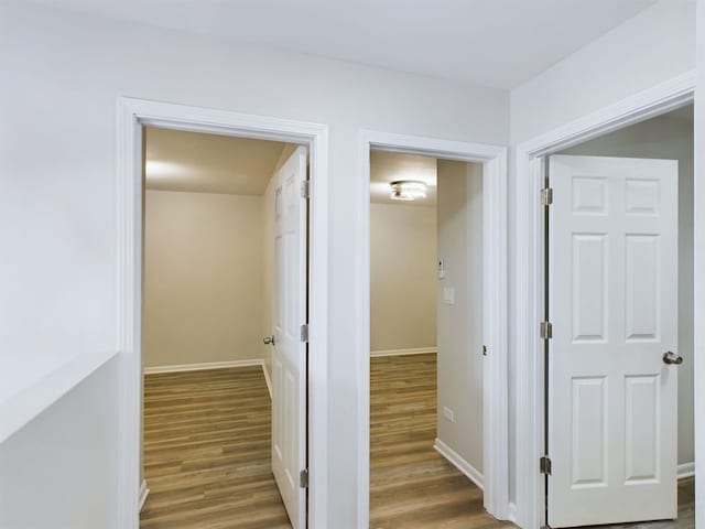 corridor with dark hardwood / wood-style floors