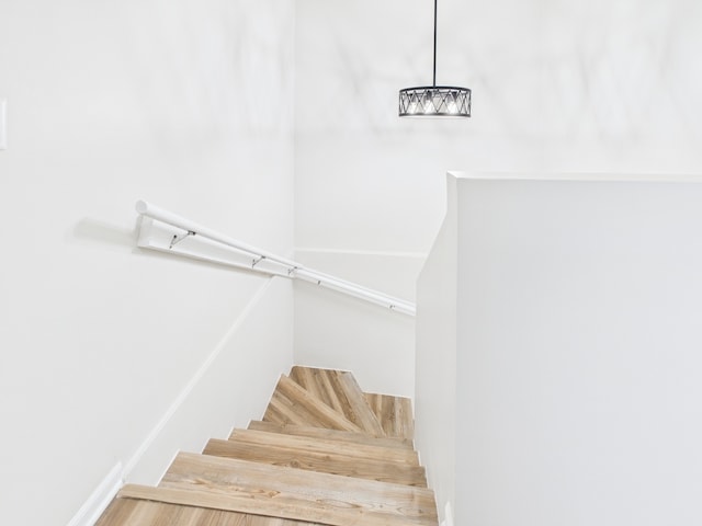 stairs featuring an inviting chandelier