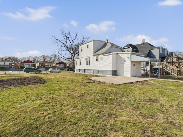 back of property featuring a yard and a patio area