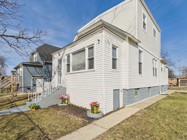 view of side of property with a lawn