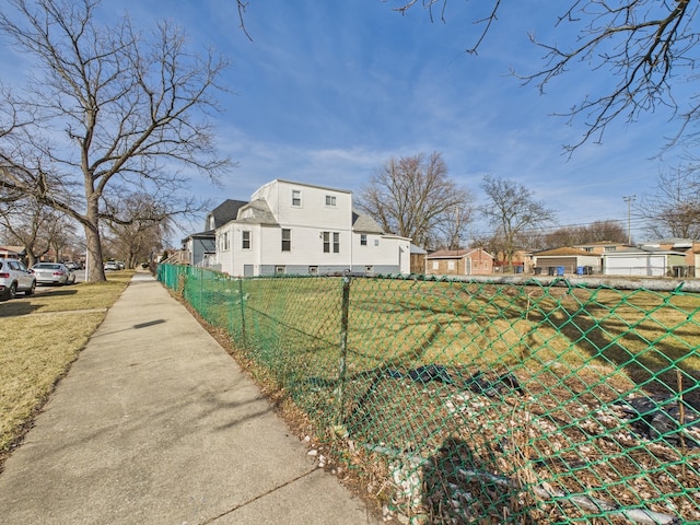 view of side of property featuring a yard and fence