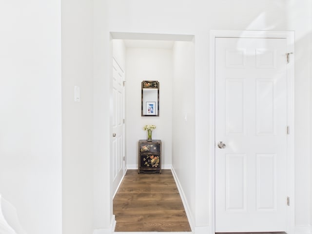 hall with dark wood finished floors and baseboards