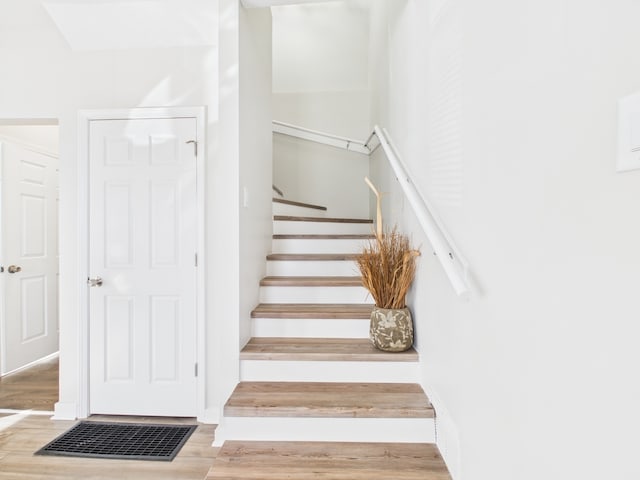 stairway featuring wood finished floors