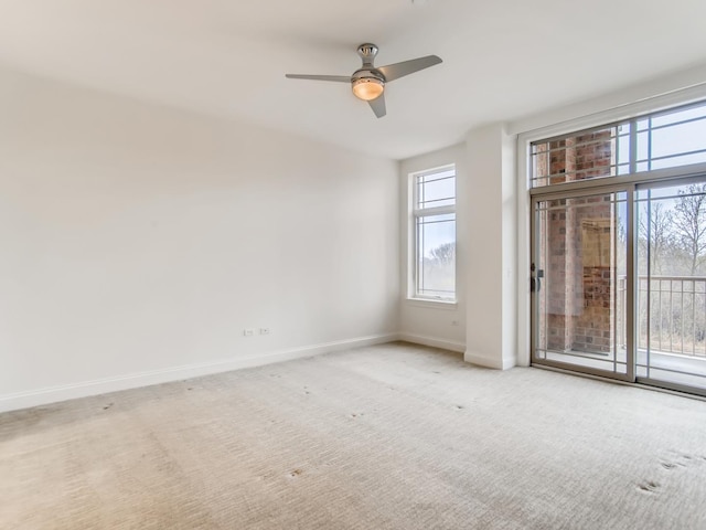 empty room with ceiling fan and light colored carpet