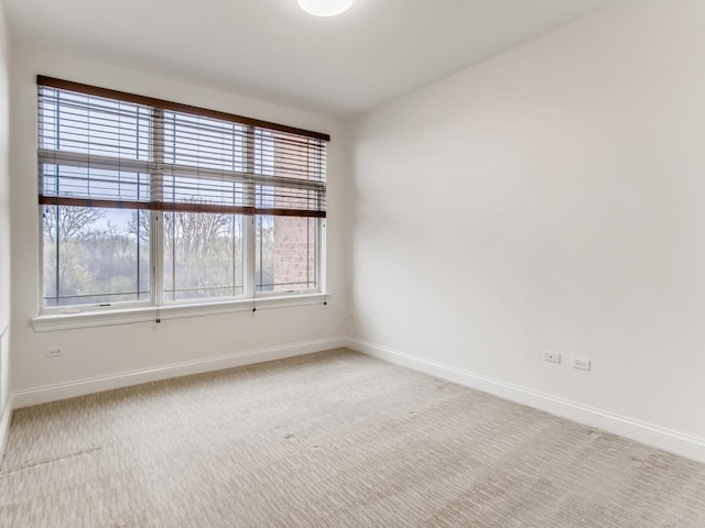 spare room with light colored carpet