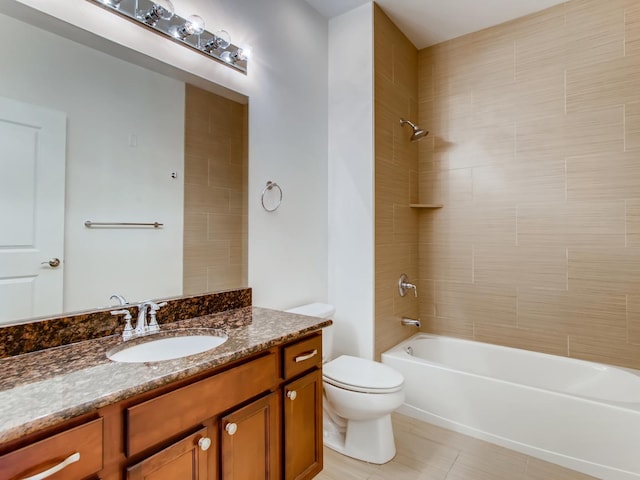 full bathroom with vanity, tiled shower / bath, tile patterned floors, and toilet