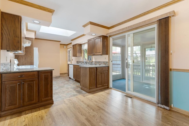 665 S Circle Ave, Port Barrington, IL 60010 - kitchen featuring a skylight, ornamental molding, white dishwasher, light wood finished floors, and stove
