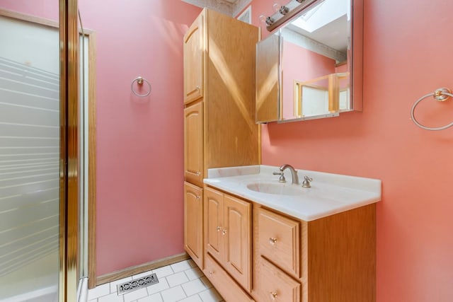 665 S Circle Ave, Port Barrington, IL 60010 - bathroom with a skylight, vanity, and tile patterned flooring