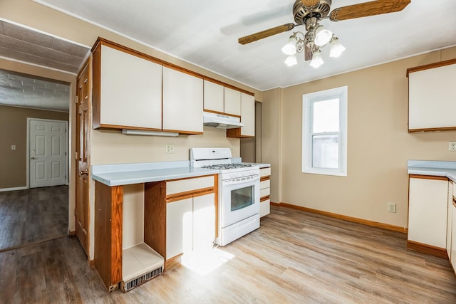 kitchen featuring white cabinetry, ceiling fan, white gas range oven, and light hardwood / wood-style flooring