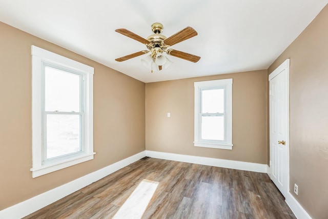 spare room with hardwood / wood-style flooring and ceiling fan