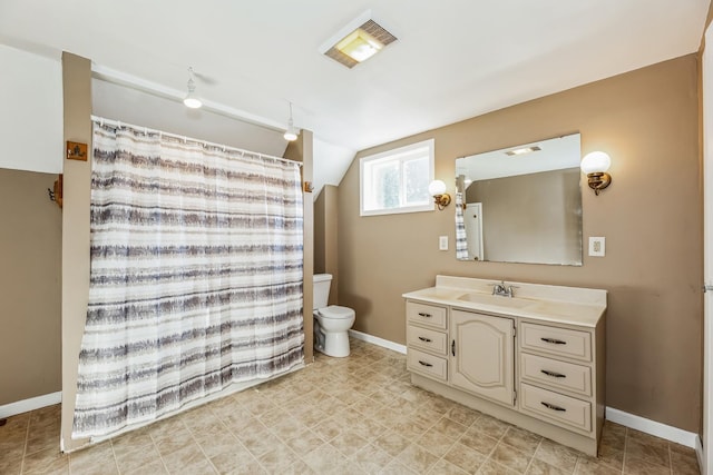 bathroom with lofted ceiling, vanity, and toilet