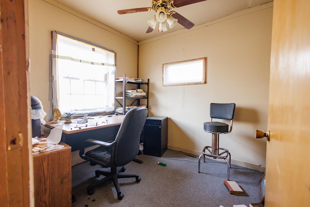 carpeted home office featuring ornamental molding and ceiling fan