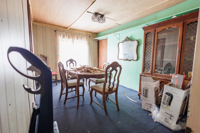 dining room with wood walls