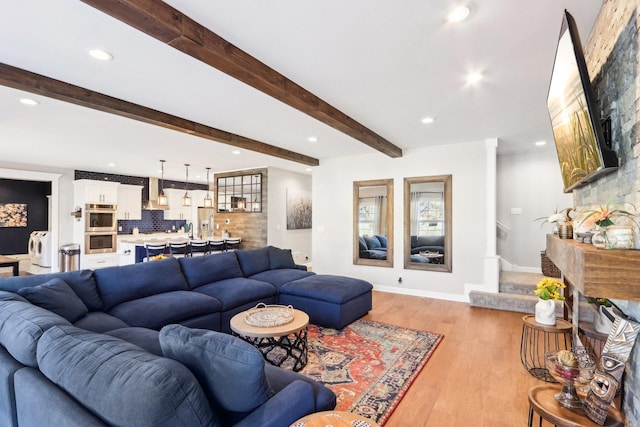 living room featuring recessed lighting, baseboards, stairs, light wood-type flooring, and beam ceiling