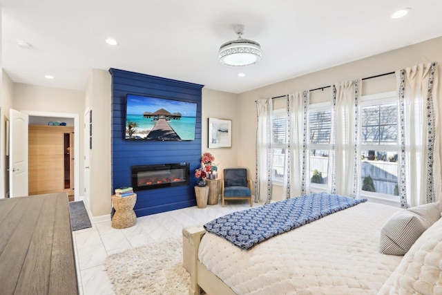 bedroom with recessed lighting, a fireplace, and baseboards