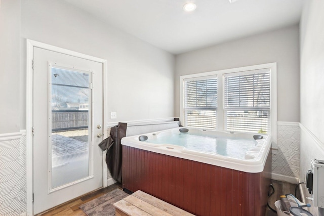 bathroom with wood-type flooring and tile walls