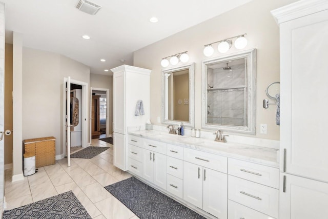 full bathroom featuring double vanity, recessed lighting, visible vents, a sink, and a tile shower