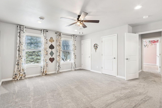 carpeted empty room with baseboards, a ceiling fan, and recessed lighting