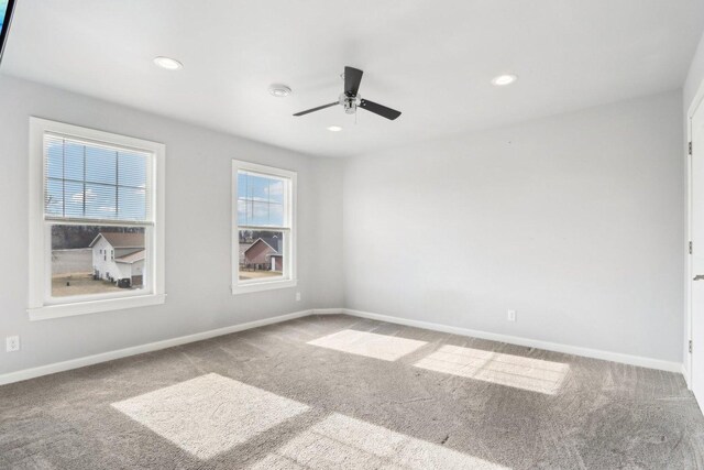 unfurnished bedroom featuring ceiling fan, light colored carpet, and connected bathroom