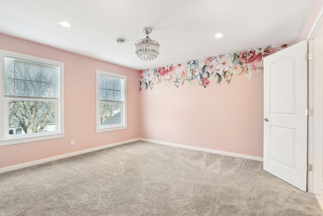 empty room featuring carpet floors, recessed lighting, and baseboards