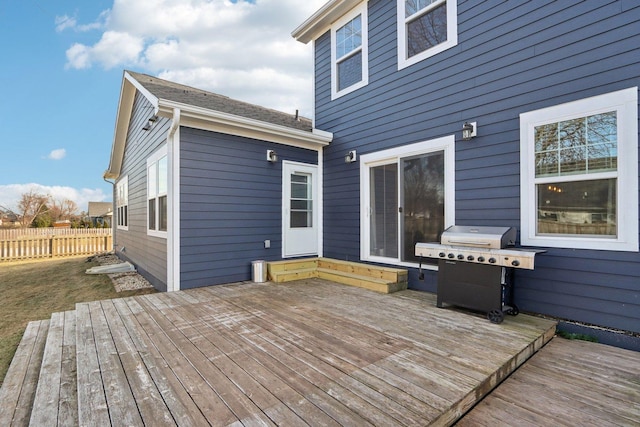 wooden terrace featuring a grill and fence