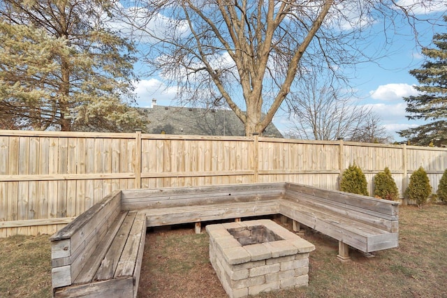 view of yard featuring an outdoor fire pit and a fenced backyard