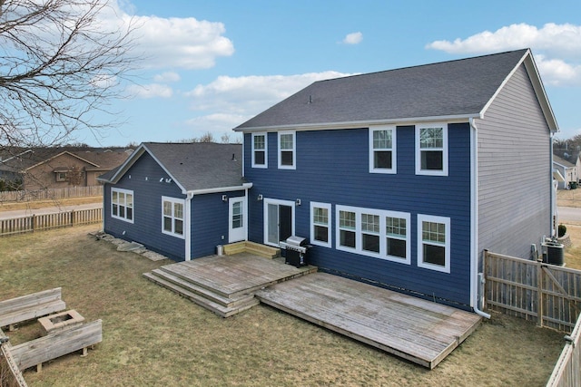 back of property featuring a fenced backyard, cooling unit, a shingled roof, a yard, and a wooden deck