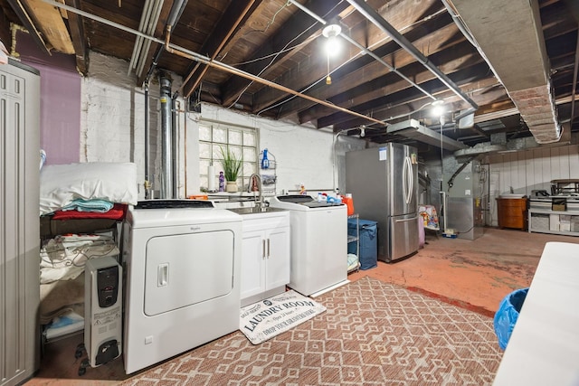 clothes washing area featuring cabinets, separate washer and dryer, sink, and heating unit