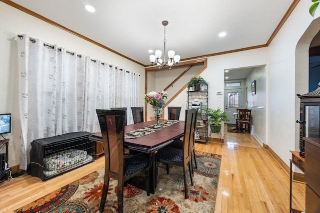 dining area featuring hardwood / wood-style flooring, ornamental molding, an inviting chandelier, and heating unit