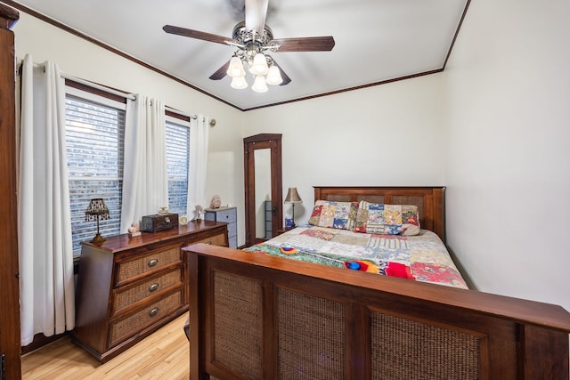 bedroom featuring crown molding, ceiling fan, and light hardwood / wood-style floors