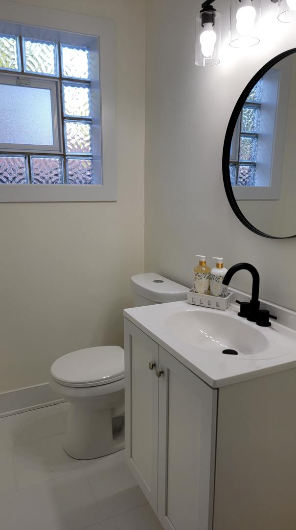 bathroom featuring tile patterned floors, vanity, and toilet