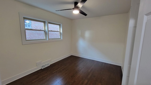 empty room with dark wood-type flooring and ceiling fan