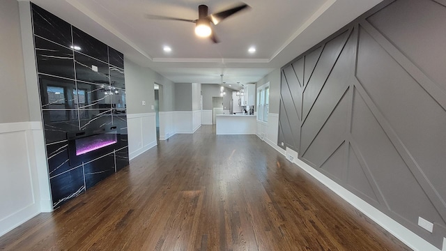 unfurnished room featuring ceiling fan, dark hardwood / wood-style flooring, and a raised ceiling