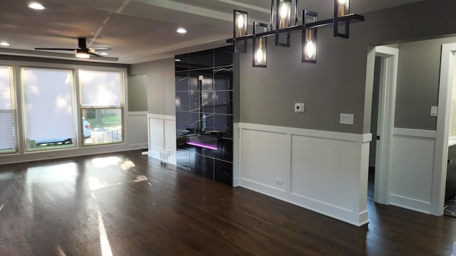 empty room with dark hardwood / wood-style floors and ceiling fan