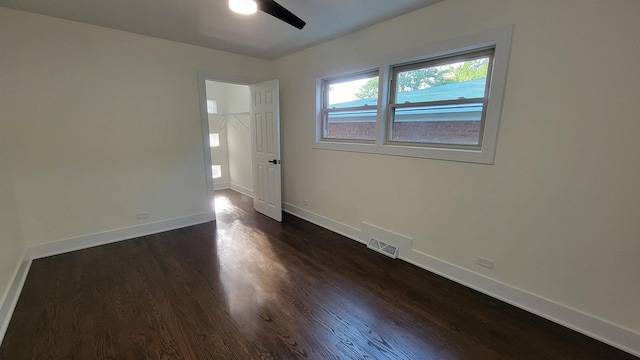 empty room featuring ceiling fan and dark hardwood / wood-style floors