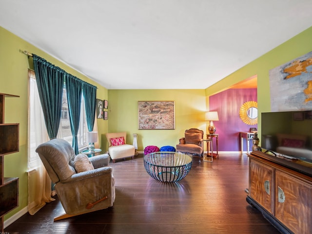 living room with baseboards and wood finished floors