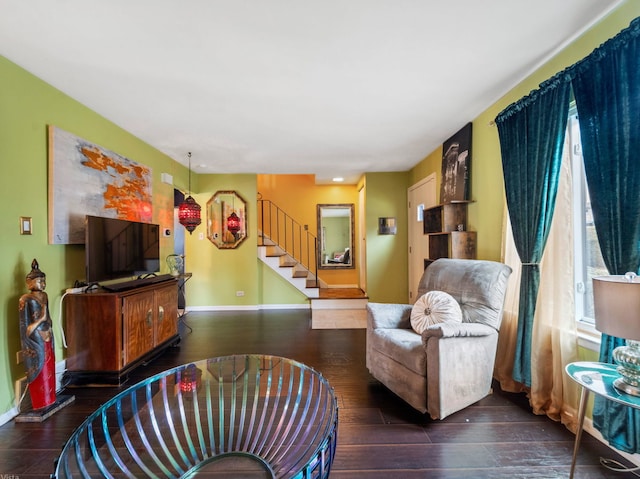 living room featuring wood-type flooring, stairs, baseboards, and a wealth of natural light