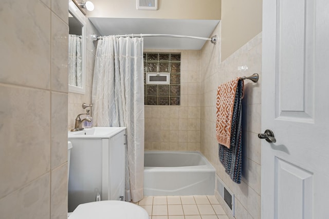 full bathroom featuring tile patterned floors, toilet, shower / tub combo, tile walls, and vanity