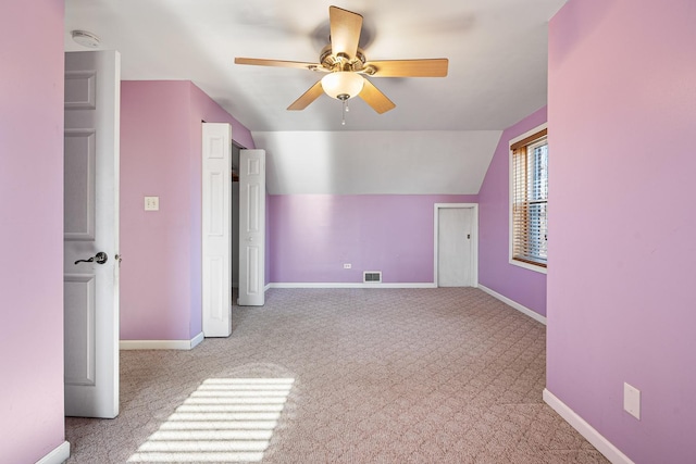 bonus room with lofted ceiling, light colored carpet, and ceiling fan