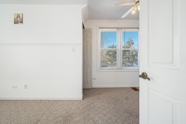 empty room featuring carpet flooring and ceiling fan