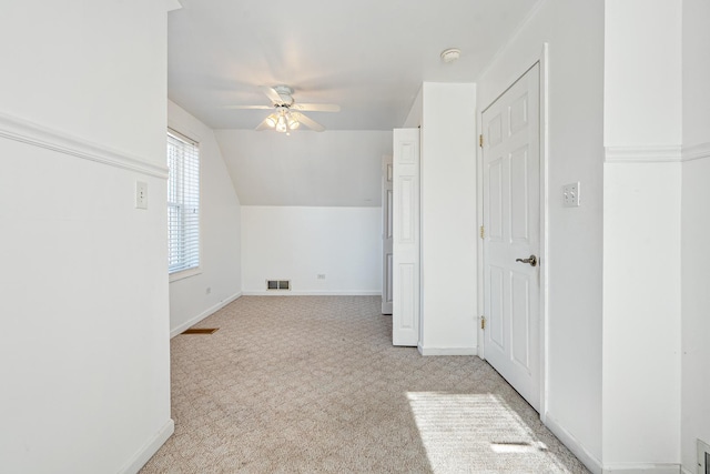 additional living space with lofted ceiling, light carpet, and ceiling fan