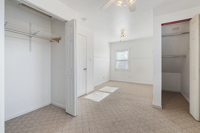 unfurnished bedroom featuring light colored carpet, a closet, and ceiling fan