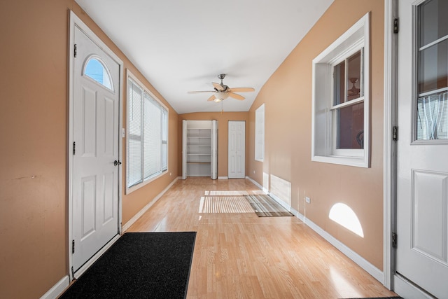 foyer with lofted ceiling, ceiling fan, and light wood-type flooring