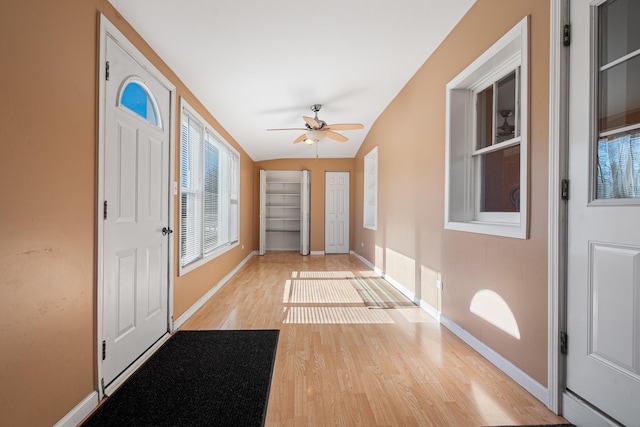 foyer entrance featuring lofted ceiling, light hardwood / wood-style flooring, and ceiling fan