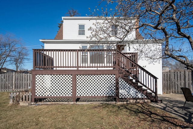 rear view of property with a yard and a deck