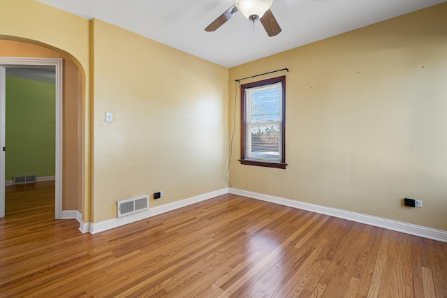 spare room with ceiling fan and light wood-type flooring