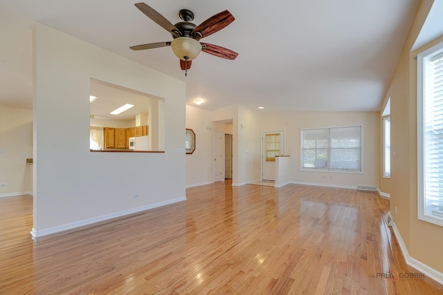 unfurnished living room featuring vaulted ceiling, ceiling fan, and light hardwood / wood-style floors