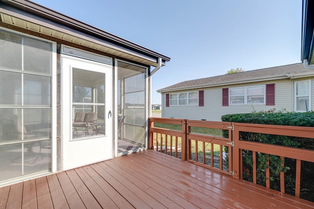 wooden deck featuring a sunroom