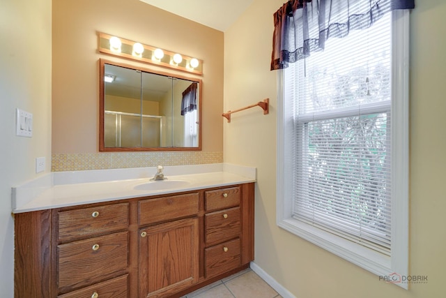 bathroom with tile patterned flooring, vanity, and a shower with shower door