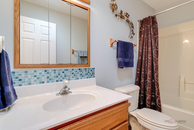 full bathroom featuring vanity, backsplash, shower / bath combination with curtain, and toilet